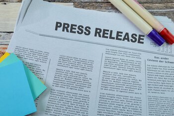 press release with news paper stack